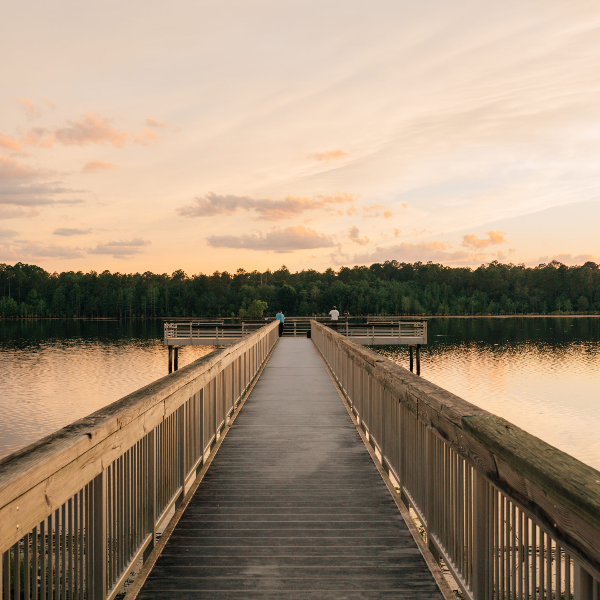 lake view with boardwalk and sunset